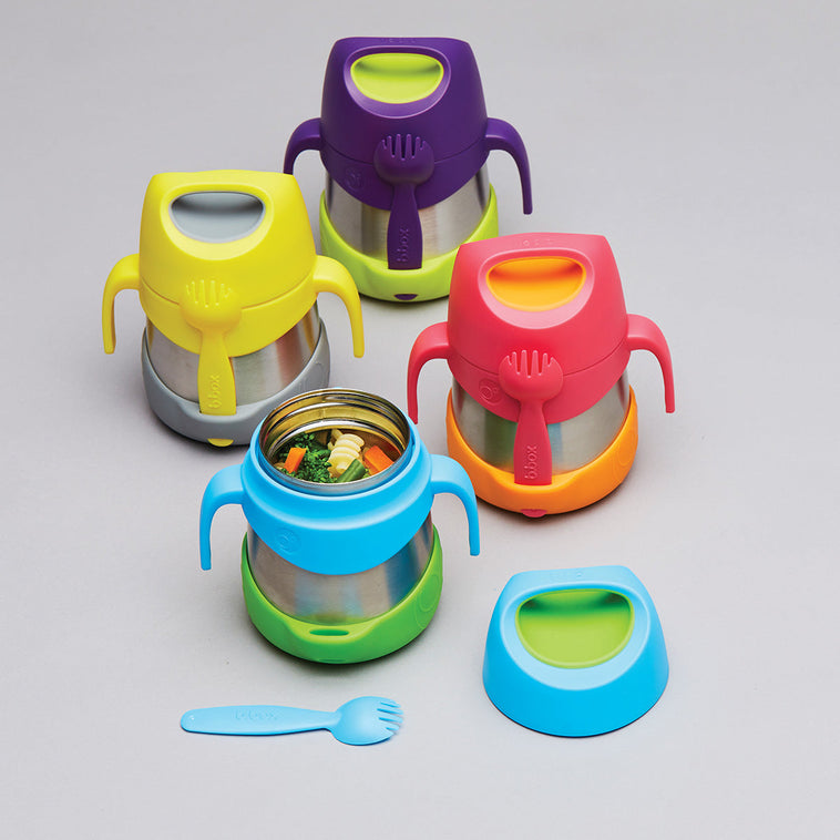 Range of b.box insulated food jars in bright colorways with stainless steel bodies, easy-grip handles and included forks, one open showing warm vegetables inside