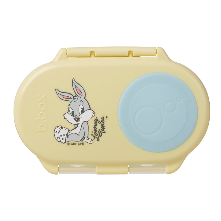 A yellow Looney Tunes themed snackbox with a character illustration and a blue seal.